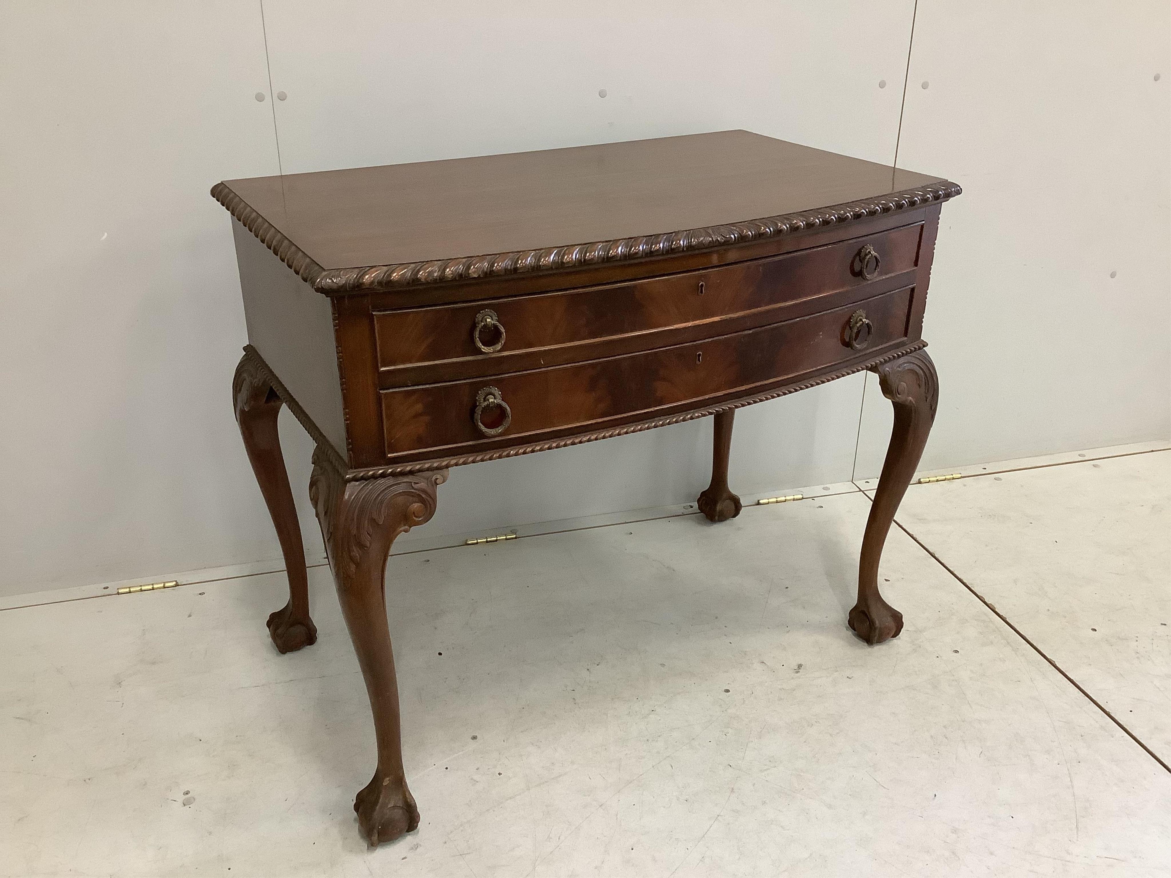 A Chippendale Revival mahogany dining suite comprising extending dining table, 210cm extended, two spare leaves, depth 106cm, height 75cm, bowfront sideboard and serving table, together with six dining chairs (two with a